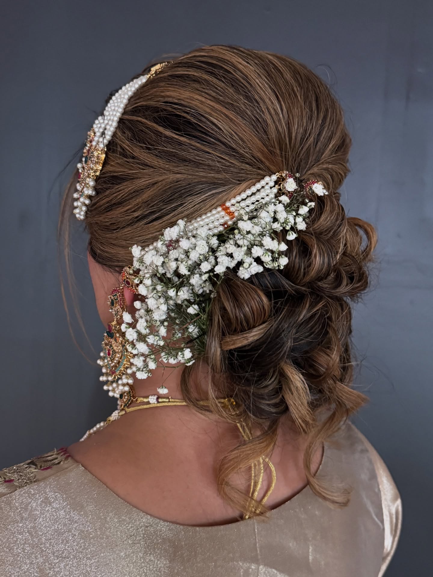 Bridal updo with baby's breath by Fefe Artist